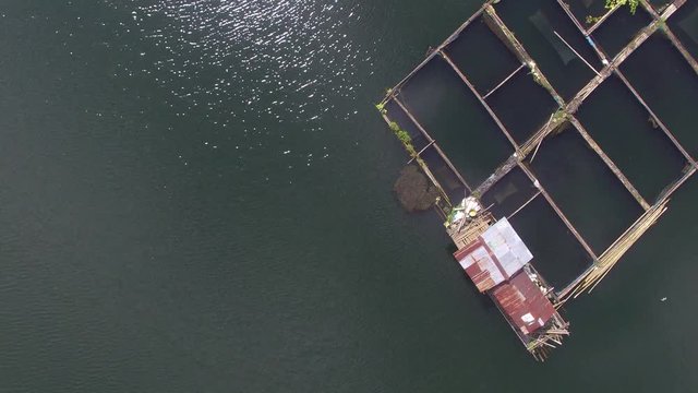 Sampaloc Lake, San Pablo City, Laguna, Philippines - November 21, 2017:  Bamboo fish cages built in the middle of mountain lake. Drone aerial shot