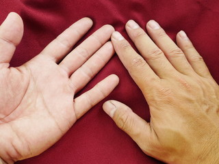 Fototapeta premium human hand on red cloth,cotton fabric background,red silk satin