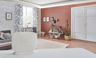 Router and Modem internet box close up and on the white table. Modern home background. Internet is in the home detail.