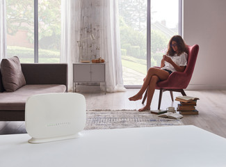 Router and Modem internet box close up and on the white table. Modern home background. Internet is...