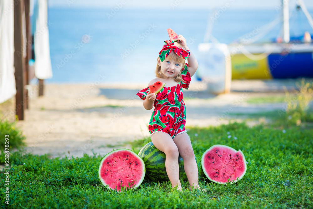 Wall mural happy child on the sea tropical beach with watermelon in hands enjoy life time weekend wearing fancy