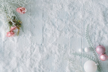 White wooden table background with snow and Christmas decoration. Creative winter top view. Minimal flat lay with copy space.