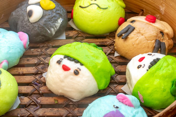 Steamed bun Cartoon in the basket of wood.