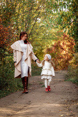 Naklejka na ściany i meble charming beautiful mother walks with little daughter girl