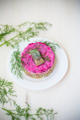 layered salad of boiled vegetables with beets and herring