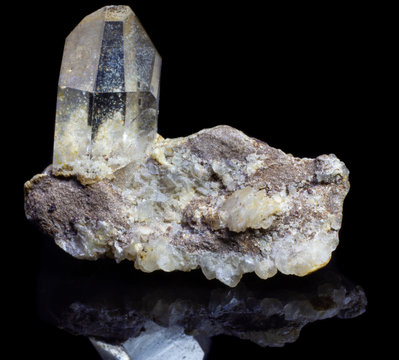 Natural quartz rock rhinestone on a substrat on a black background