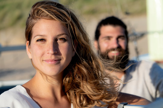 Couple on the beach, woman looking at camera