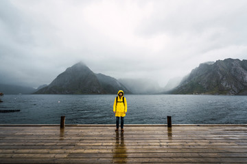 Norway, Lofoten, man standing on a pier at the coast