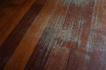 Old scratched hardwood flooring in need of maintenance. parquet ruined by scratches made by prolonged use of chair.