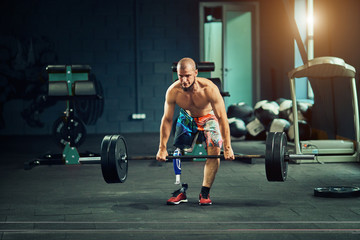 Fototapeta na wymiar Sportsman with prosthesis working out in gym