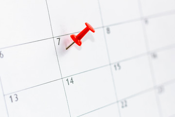 7 date pinning on calendar with Red color pin thumbtack. Save the Date concept.