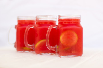Homemade lemonade from watermelon and lemon in glass cups on a light background