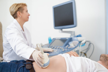 Man lying in equipped medical office on examination.