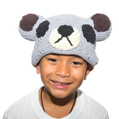 Boy wearing a yarn hatt was smiling.