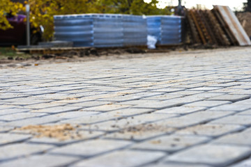 Naklejka premium new pavement of paving slabs, new street being paved
