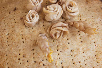 Cake with decorations of roses and twigs. Candid.