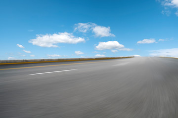 Empty highway asphalt pavement and sky cloud landscape..