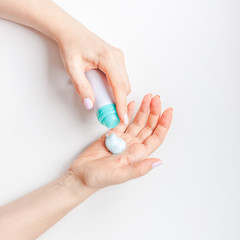 Woman moisturizing her hands with foam lotion
