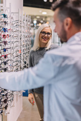 Woman and optician choosing glasses