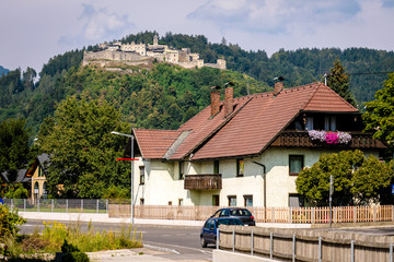 Austrian mountain town scenery with fortress in the background.