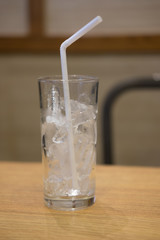 Empty glass with ice cube