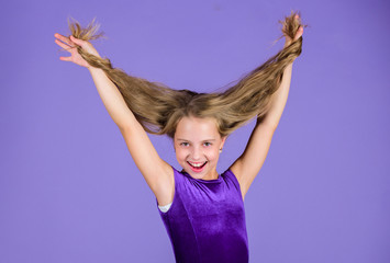 Kid girl with long hair wear dress on violet background. Hairstyle for dancer. How to make tidy hairstyle for kid. Things you need know about ballroom dance hairstyle. Ballroom latin dance hairstyles - obrazy, fototapety, plakaty