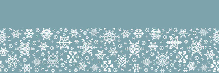 Horizontal border of white snowflakes on a blue background