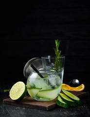 Cocktail Gin with Cucumber. Alcoholic cocktail. On a wooden background. Top view. Free copy space.