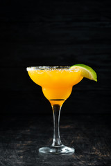 Margarita Mango. Alcoholic cocktail. On a wooden background. Top view. Free copy space.