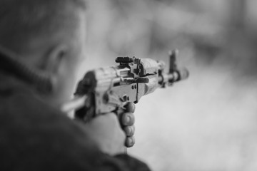 Soldier shoots from assault rifle