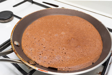 Cooked chocolate pancake in a pan