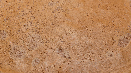 The texture of the surface of a chocolate pancake