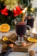 Christmas red mulled wine in glass on wood board at white background