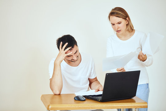 Frustrated couple, high taxes, reading mail paper from bank at home, financial problems, domestic bills