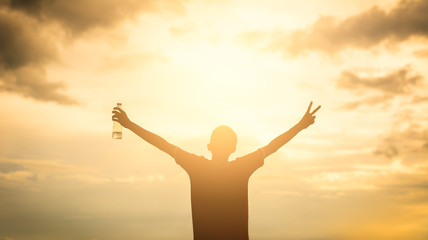 silhouette of man with open arms raised