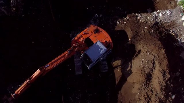 San Pablo City, Laguna, Philippines - November 13, 2017: backhoe loader bucket excavator digging ground soil where building structure is to be built. Drone aerial shot