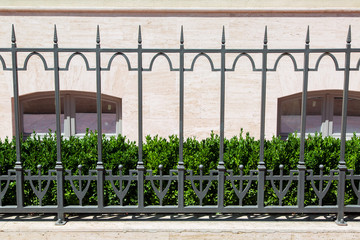 The fence in retro style is set for the fencing of greenery from the bushes in front of the...