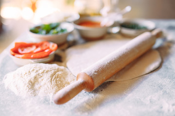 Cooking Pizza. Pizza ingredients on the  table.