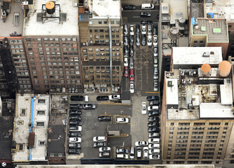 Top view on the cars in the parking lot in New York. View from skyscrapers on the streets of New York City.