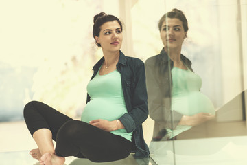 pregnant women sitting on the floor