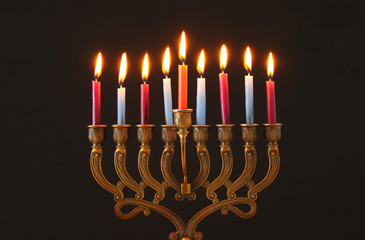 image of jewish holiday Hanukkah background with menorah (traditional candelabra) and candles.