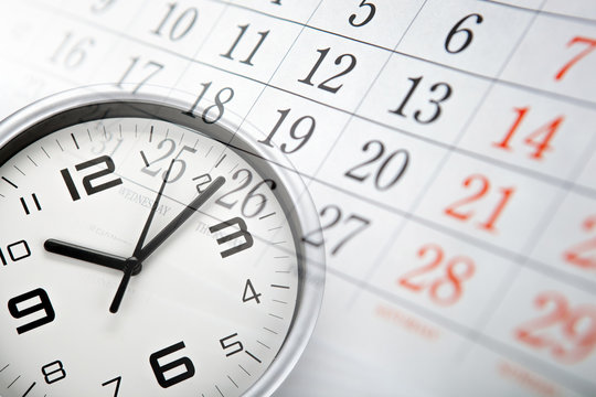 wall calendar with the number of days and white clock face