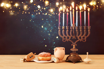 image of jewish holiday Hanukkah background with menorah (traditional candelabra) and burning...