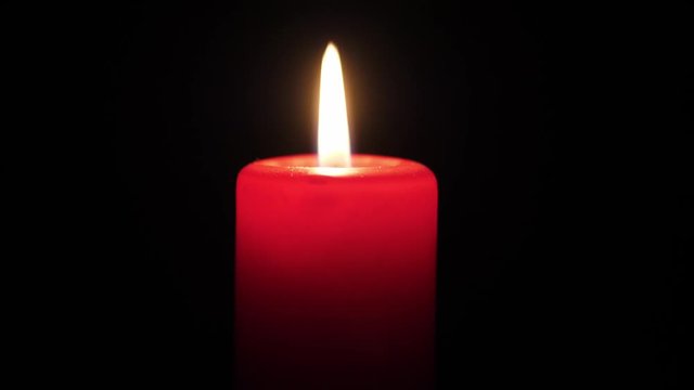 Red candle on a black background