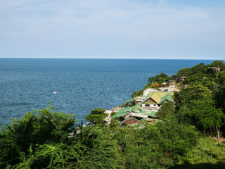 Fototapeta na wymiar Fishing village on the hillside on the seashore in summertime.