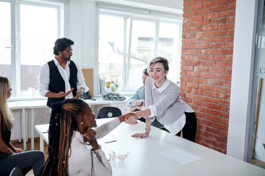 blond charming girl greeting with new colleagues. first working day, new company. argument, pari