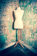 mannequin dress form vintage, decaying wall of abandoned building, grunge  colours cross processed...