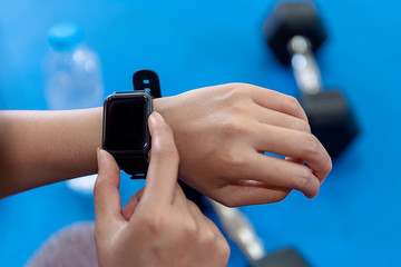 Closeup of smartwatch on a wrist. Female hand with smartwatch and sport concept.