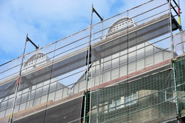 Gerüst mit Sicherheitsnetz bei der Sanierung eines denkmalgeschützten Gebäudes mit kunstvoller...