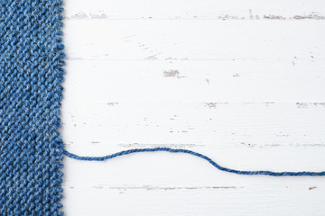 Unravelling knitted fabric on white background